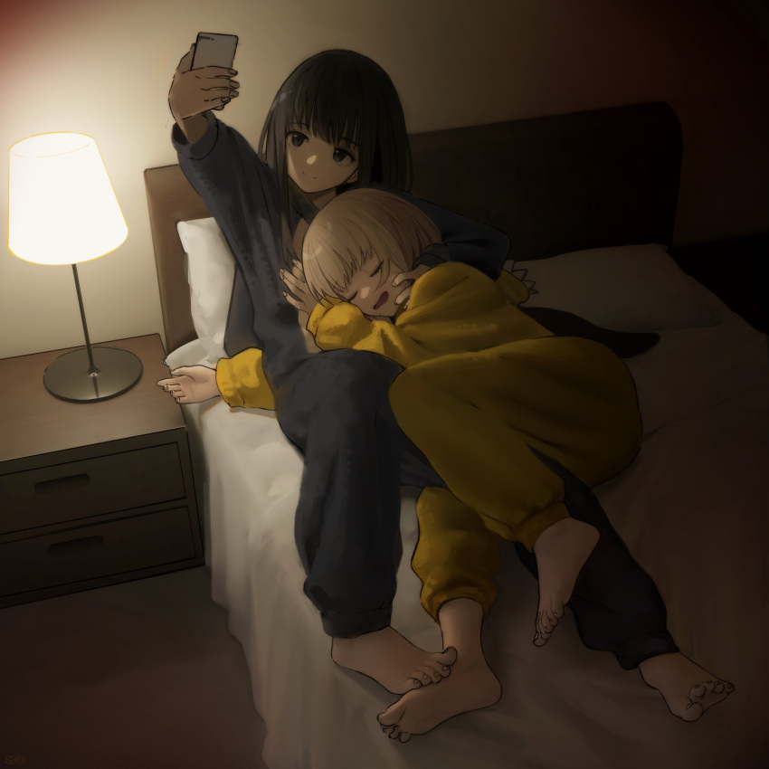 2girls, barefoot, bed, bed_sheet, black_hair, blonde_hair, closed_mouth, cuddling