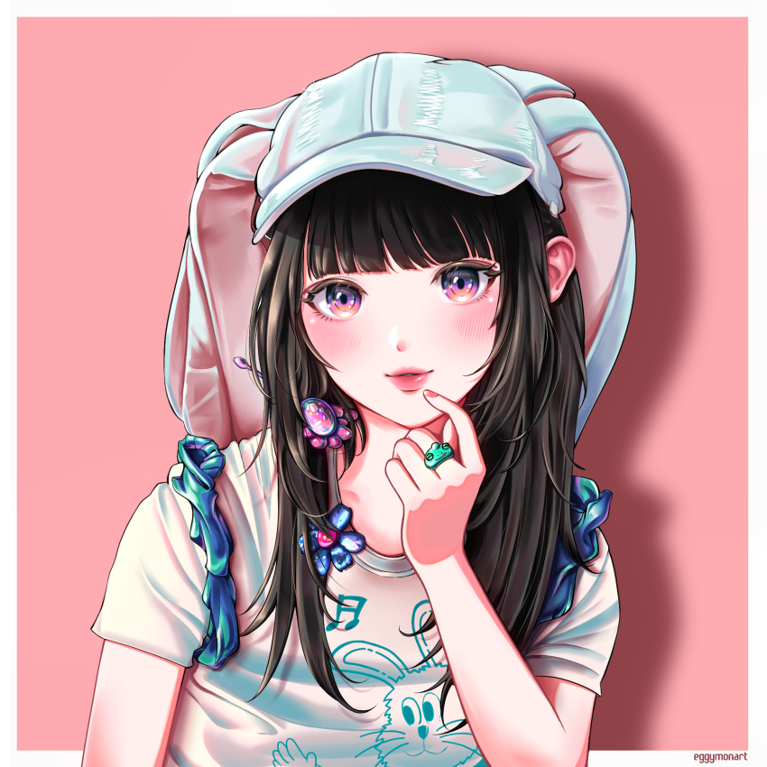 1girl, animal_hat, animification, artist_name, baseball_cap, blue_headwear, blush, border, eggymon, hair_behind_ear, hanni_(newjeans), hat, highres, jewelry, k-pop, long_hair, looking_at_viewer, newjeans, parted_lips, pink_background, pink_eyes, portrait, print_shirt, rabbit_hat, real_life, ring, shirt, smile, solo, white_border, white_shirt