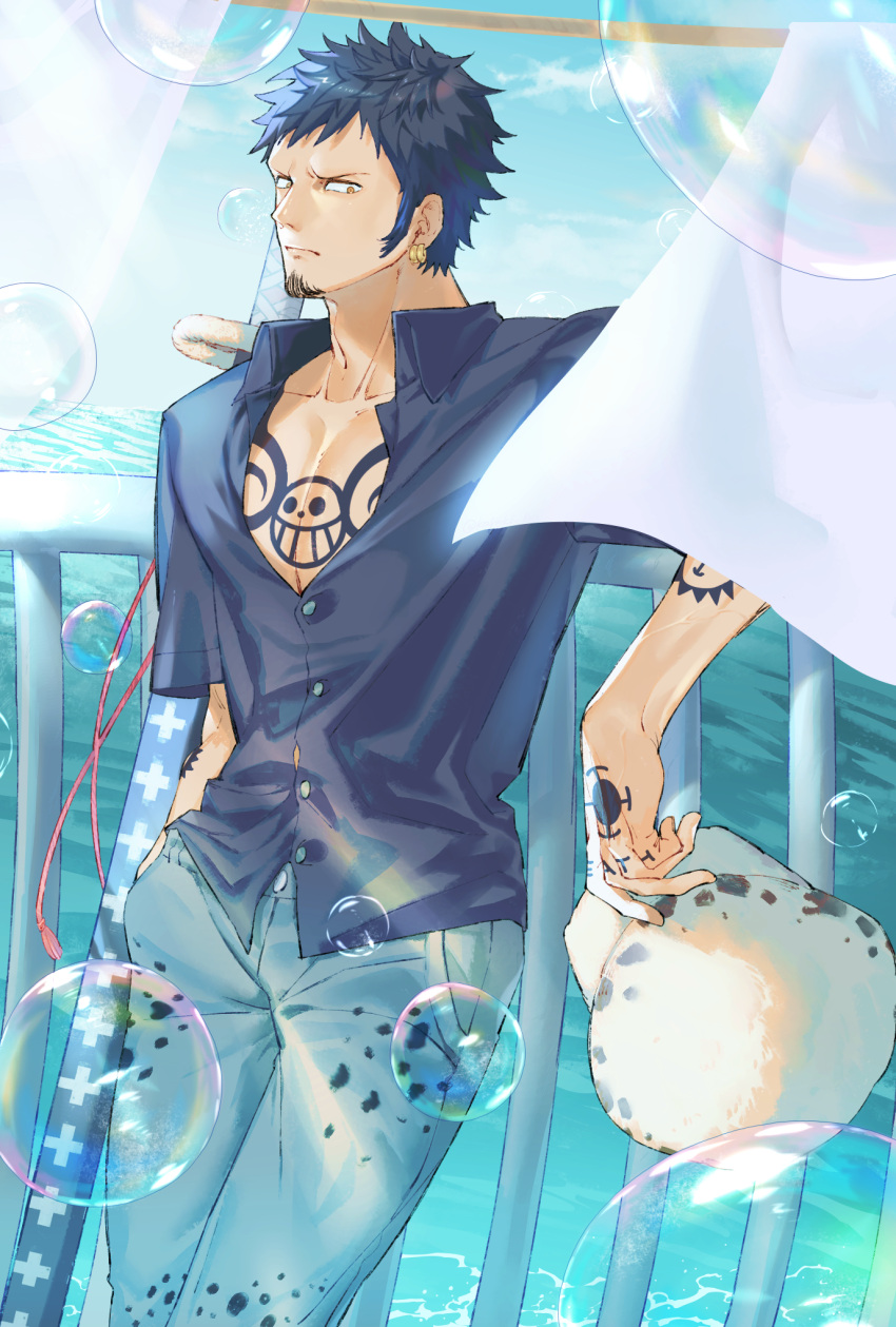 arm_tattoo, blue_shirt, bubble, chest_tattoo, collarbone, collared_shirt, denim, earrings, facial_hair, finger_tattoo, goatee, gunjo_shizuko, hand_in_pocket, hand_tattoo, highres, jaguar_print, jeans, jewelry, long_sideburns, male_focus, ocean, one_piece, pants, pectoral_cleavage, pectorals, sheath, sheathed, shirt, sideburns, sword, tattoo, trafalgar_law, weapon, yellow_eyes
