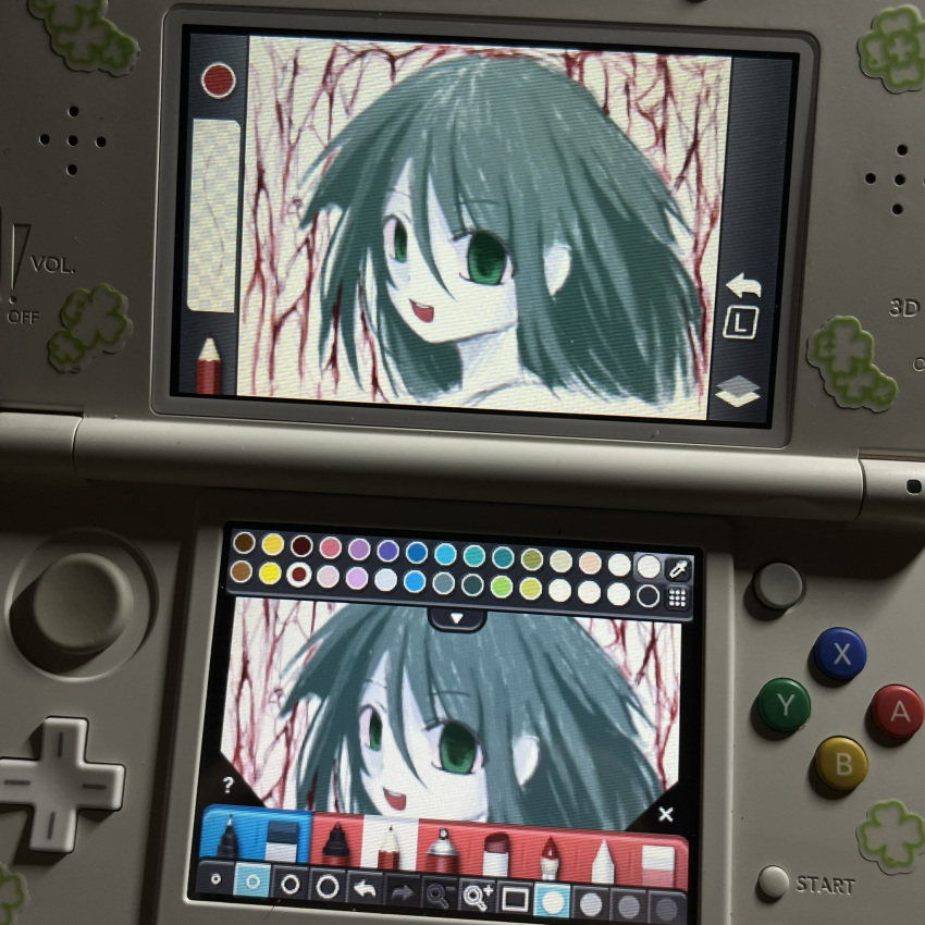 1girl, blood, colored_skin, drawing, english_text, game_console, green_eyes, green_hair, hair_between_eyes, highres, horror_(theme), human_experiment_(wwinterdotcom), long_hair, looking_at_viewer, nintendo_ds_(medium), open_mouth, photo_(medium), portrait, saya_no_uta, smile, solo, staring, sticker, teeth, upper_teeth_only, white_skin