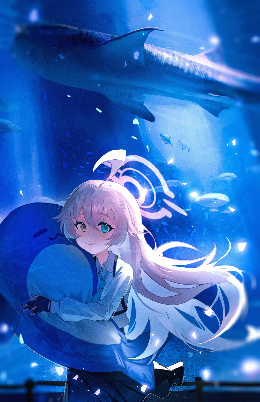 1girl, :3, absurdres, ahoge, aquarium, black_skirt, blue_archive, blue_eyes, chest_harness, closed_mouth, collared_shirt, commentary, dot_nose, fish, hair_between_eyes, hair_flaps, halo, harness, highres, holding, holding_stuffed_toy, hoshino_(blue_archive), huge_ahoge, indoors, long_hair, looking_at_viewer, pink_hair, pink_halo, shirt, skirt, smile, solo, stuffed_toy, stuffed_whale, tansuan_(ensj3875), upper_body, white_shirt, yellow_eyes
