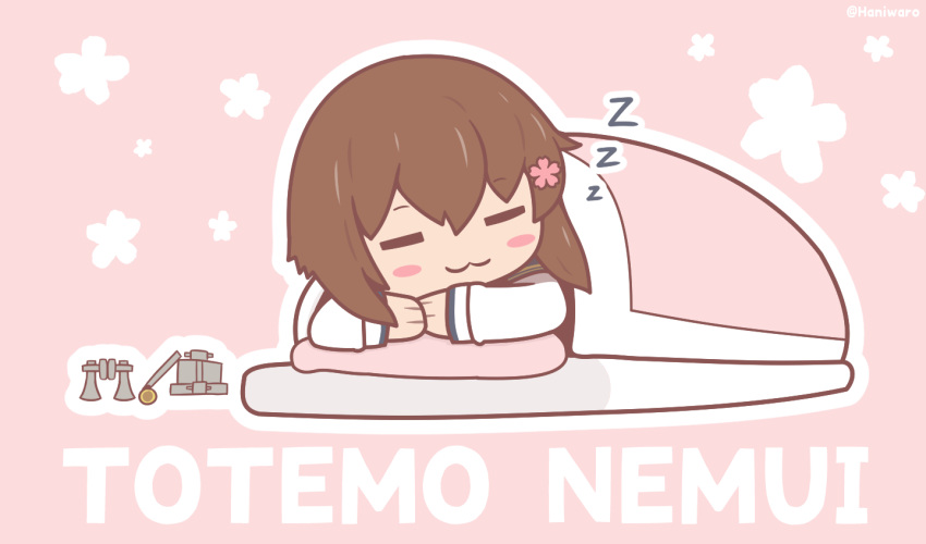 1girl, ;3, blanket, brown_eyes, brown_hair, closed_eyes, commentary_request, flower, futon, hair_flower, hair_ornament, haniwaro, kantai_collection, lying, on_stomach, one_eye_closed, pillow, pink_background, romaji_text, short_hair, sleeping, solo, unworn_headgear, yukikaze_(kancolle), yukikaze_kai_ni_(kancolle), zzz