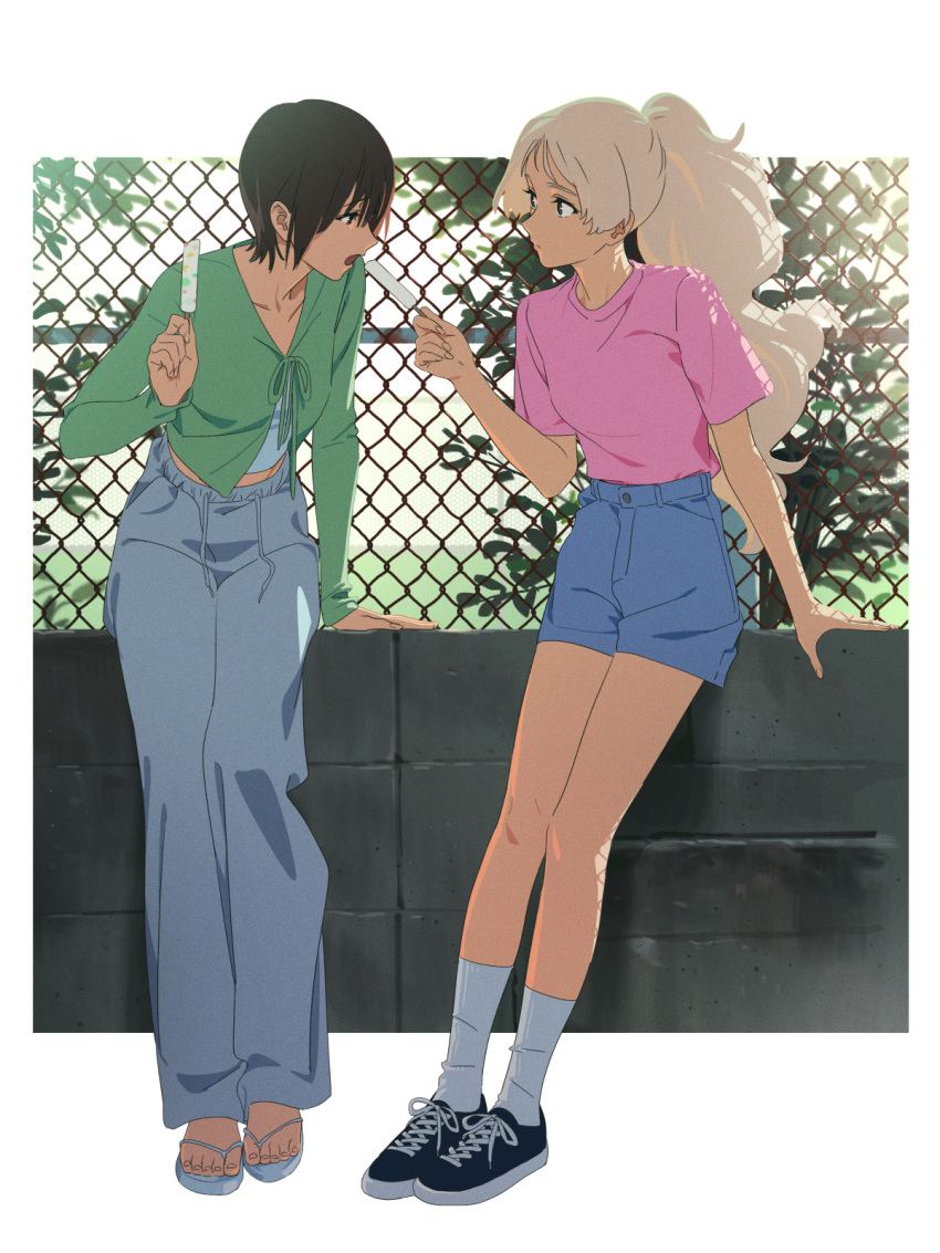 2girls, black_hair, blue_shorts, chain-link_fence, commentary, eating, feeding, fence