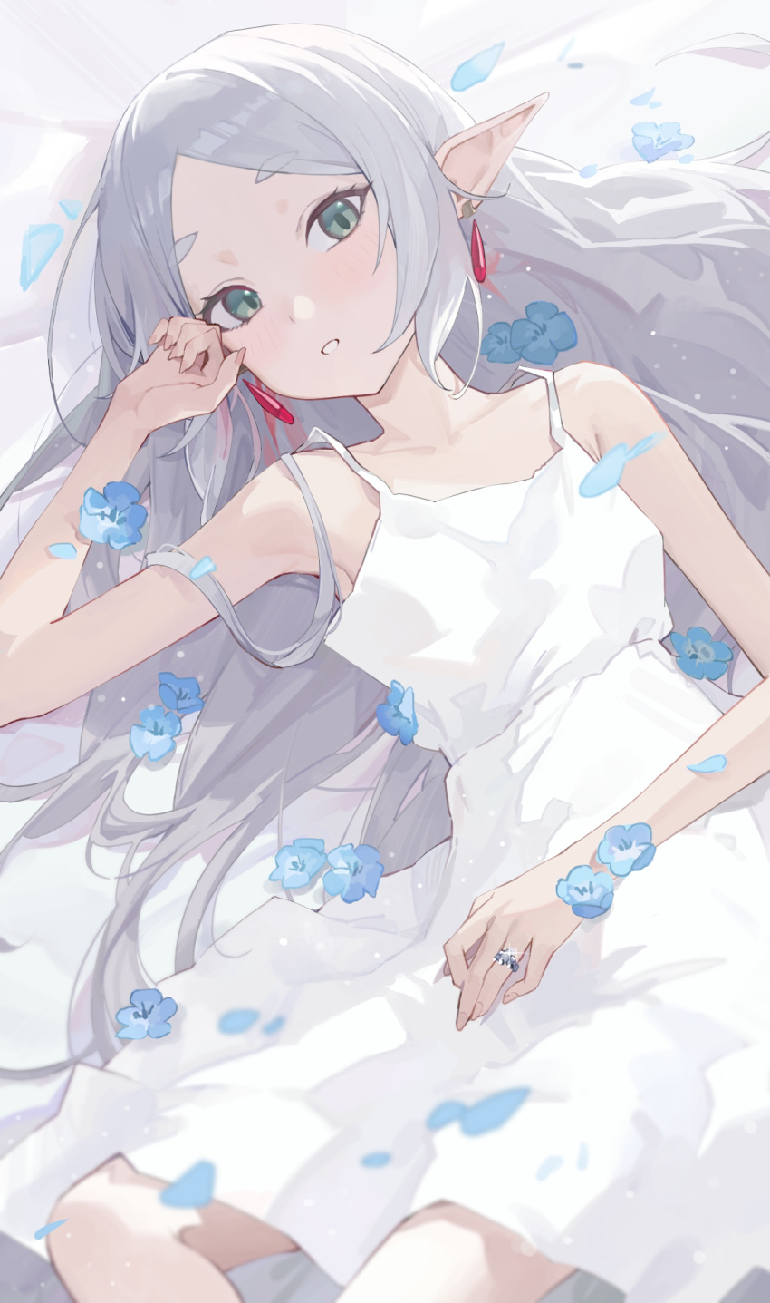 1girl, bare_arms, bare_shoulders, blue_flower, collarbone, cowboy_shot, dress, earrings, elf, fingernails, flower, frieren, green_eyes, highres, indoors, jewelry, light_blush, light_particles, long_hair, looking_at_viewer, lying, on_back, parted_bangs, parted_lips, pointy_ears, ring, shi_classmate, short_eyebrows, sidelocks, sleeveless, sleeveless_dress, solo, sousou_no_frieren, thick_eyebrows, white_dress, white_hair