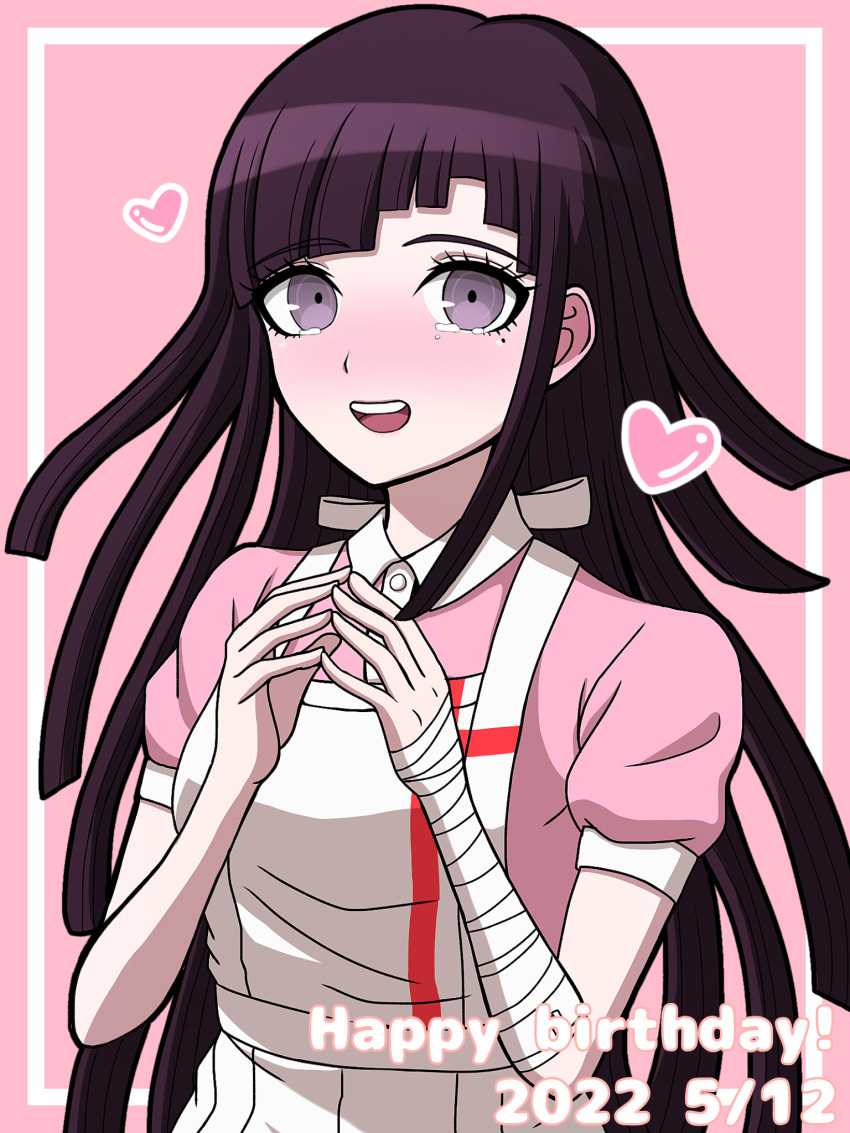 1girl, :d, apron, breasts, collared_shirt, cowboy_shot, danganronpa_(series), danganronpa_2:_goodbye_despair, dated, happy_birthday, heart, highres, long_hair, medium_breasts, mole, mole_under_eye, own_hands_together, pink_background, pink_eyes, pink_shirt, puffy_short_sleeves, puffy_sleeves, purple_hair, shirt, short_sleeves, smile, solo, suiren_yurei, tearing_up, teeth, tsumiki_mikan, upper_teeth_only, white_apron