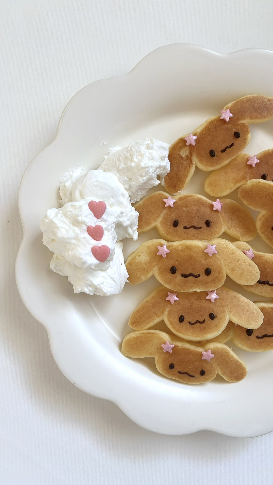 :3, animal, animal_focus, butter, chyeyhc, commentary_request, dog, food, food_art_(medium), fuwa_fuwa_cinnamoroll, heart, highres, korean_commentary, mocha_(cinnamoroll), no_humans, pancake, photo_(medium), plate, sanrio, smile, solid_oval_eyes, star_(symbol), unconventional_media, white_background