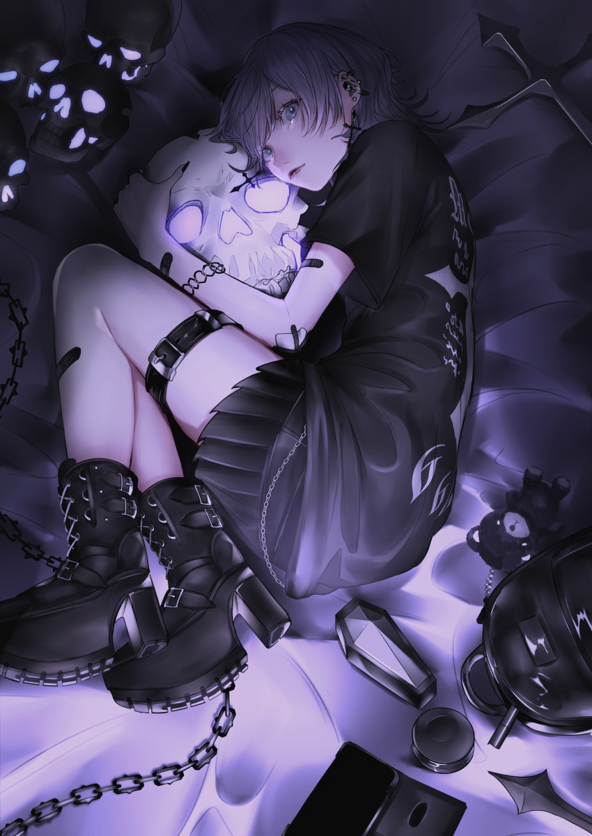 1girl, 666, absurdres, animal_charm, backpack, bag, bag_charm, barbell_piercing, bed_sheet, black_bag, black_bandaid, black_boots, black_nails, black_shirt, black_skirt, black_theme, boots, cellphone, chain, chain_bracelet, charm_(object), closed_mouth, commentary_request, cross, cross_earrings, ear_piercing, earrings, eyelashes, fetal_position, fingernails, full_body, goth_fashion, grey_eyes, grey_hair, high_heel_boots, high_heels, highres, hugging_object, jewelry, lace-up_boots, latin_cross, lipstick, long_fingernails, lying, makeup, mano_aaa, nail_polish, on_side, original, paperclip_earrings, phone, piercing, platform_boots, platform_heels, pleated_skirt, print_shirt, red_lips, shirt, short_hair, skirt, skull, skull_earrings, smartphone, smartphone_case, solo, swept_bangs, t-shirt, unworn_backpack, unworn_bag