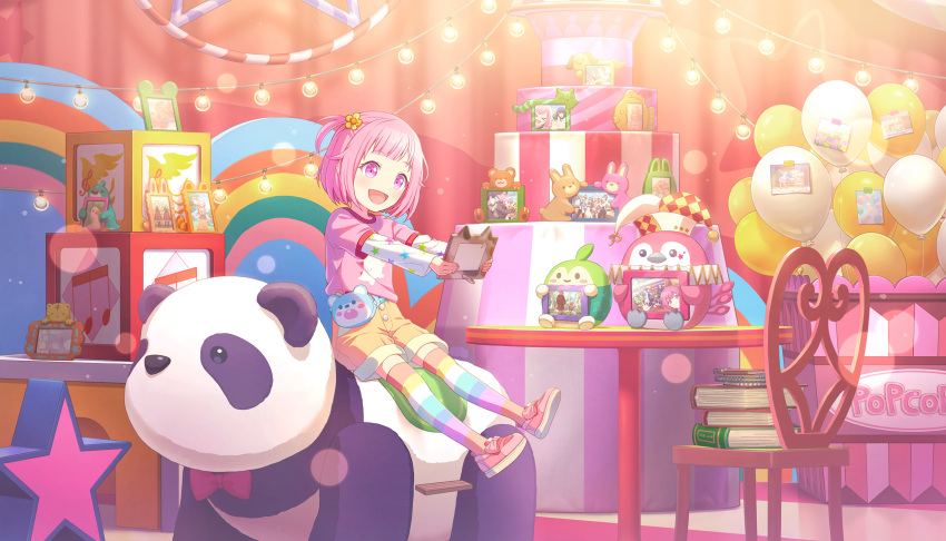 1girl, :d, aged_down, balloon, bloom_festival_(project_sekai), blush, book, chair, child, colorful_palette, flower, game_cg, hair_flower, hair_ornament, happy, highres, holding, holding_picture_frame, kamishiro_rui, kiritani_haruka, kusanagi_nene, official_art, ootori_emu, ootori_hinata, ootori_keisuke_(project_sekai), ootori_rakunosuke, ootori_shousuke, orange_shorts, phenny_(project_sekai), picture_frame, pink_eyes, pink_hair, pink_shirt, pink_shoes, project_sekai, rainbow_thighhighs, shirt, shoes, shorts, sitting, sitting_on_stuffed_toy, smile, star_(symbol), star_print, stuffed_animal, stuffed_panda, stuffed_toy, table, tenma_tsukasa, third-party_source, toy_box, yellow_flower