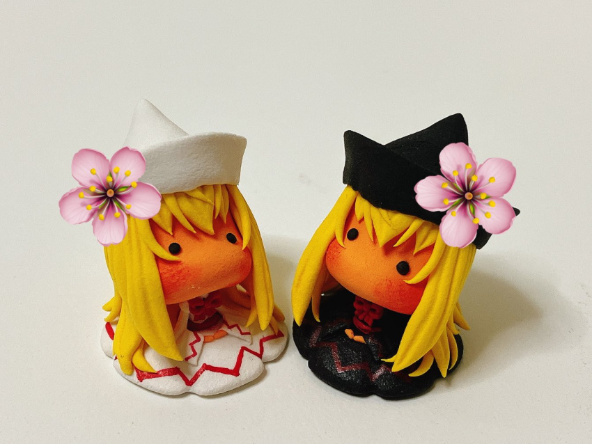 2girls, black_dress, black_eyes, black_hat, blonde_hair, cherry_blossoms, commentary_request, dress