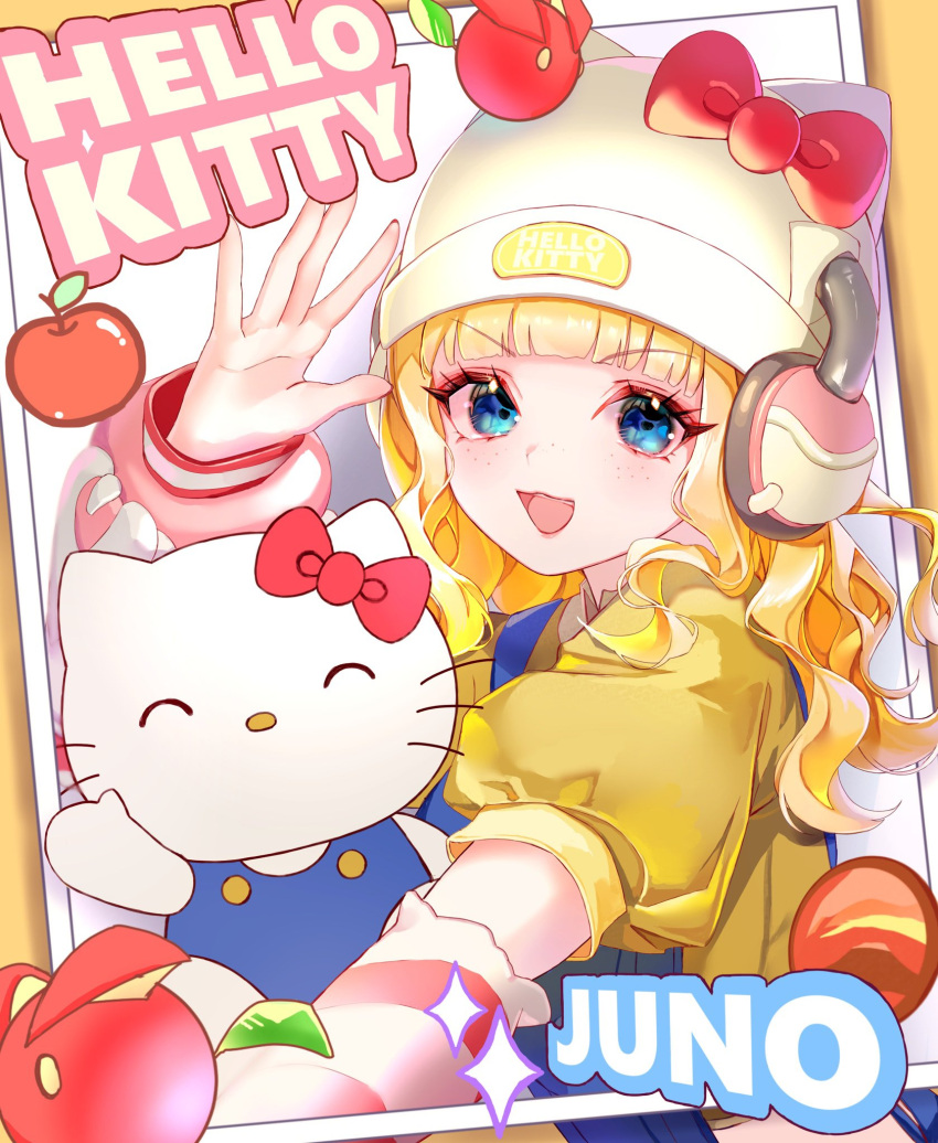 1girl, apple, arm_warmers, blonde_hair, blue_eyes, bow, cat, collared_shirt, commentary_request, food, fruit, hat, headphones, hello_kitty, hello_kitty_(character), highres, juno_(overwatch), long_hair, nano_kaname, open_mouth, overalls, overwatch, photo_(object), sanrio, shirt, striped_arm_warmers, waving, whiskers, yellow_shirt