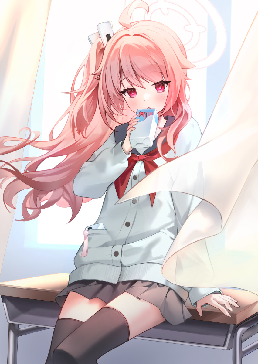 1girl, absurdres, ahoge, black_sailor_collar, black_thighhighs, blue_archive, blush, cardigan, commentary_request, curtains, desk, drink, drink_carton, drinking, grey_cardigan, halo, highres, holding, holding_drink, holding_drink_carton, holding_milk_carton, kanoina, long_hair, long_sleeves, looking_at_viewer, milk_carton, natsu_(blue_archive), neckerchief, on_desk, pink_hair, pink_halo, pleated_skirt, red_eyes, red_neckerchief, sailor_collar, school_desk, side_ponytail, skirt, solo, thigh-highs, thighs