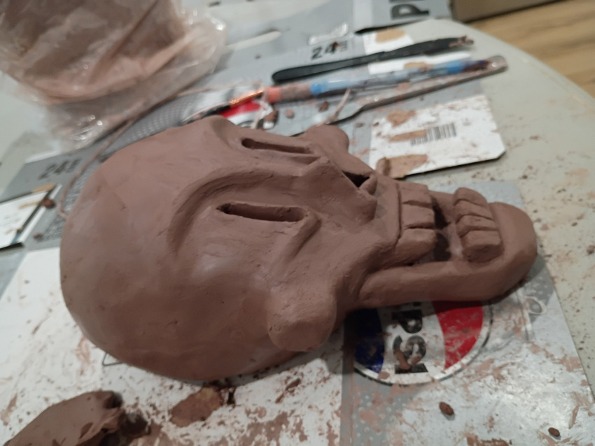1boy, 2026, art_tools_in_frame, boneteaart, clay_(medium), commentary, english_commentary, highres, humanoid, male, male_focus, male_only, monster, monster_boy, papyrus_(undertale), photo_(medium), skeleton, skull, solo, teeth, undead, undertale, unfinished, utdr_(toby_fox)