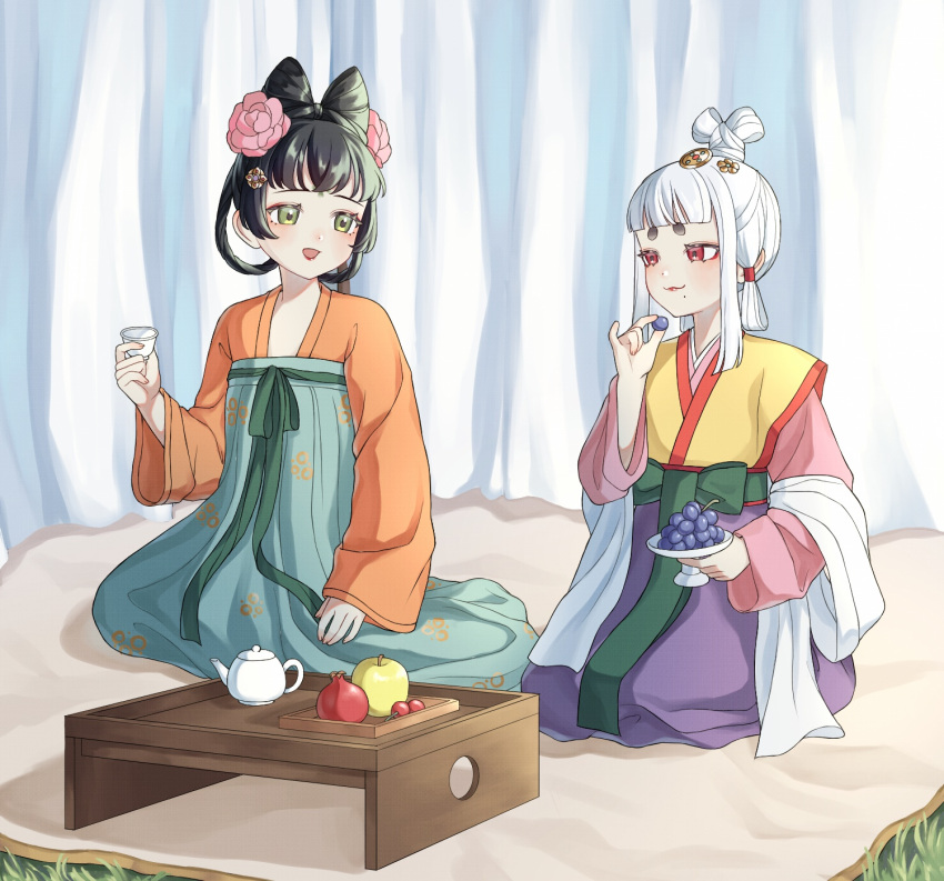 2girls, black_hair, breasts, chinese_clothes, commentary_request, cup, eye_contact, flower, food, fruit, grapes, green_eyes, hair_flower, hair_horns, hair_ornament, high-waist_skirt, highres, holding, holding_cup, japan_(kuroussa), japanese_clothes, kimono, kuroussa, looking_at_another, mole, mole_on_breast, multiple_girls, orange_hanfu, original, personification, pink_kimono, purple_skirt, red_eyes, sitting, skirt, tang_dynasty_(kuroussa), teapot, wariza, white_hair